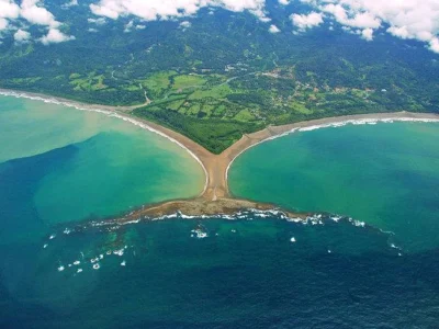 Panoramic aerial shot of Bahia Ballena coastline, showcasing pristine beaches and lush landscapes in Uvita, Costa Rica.