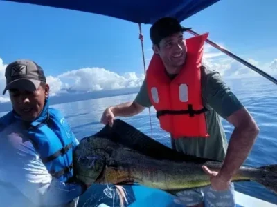 Proud fisherman holding large marlin on deck